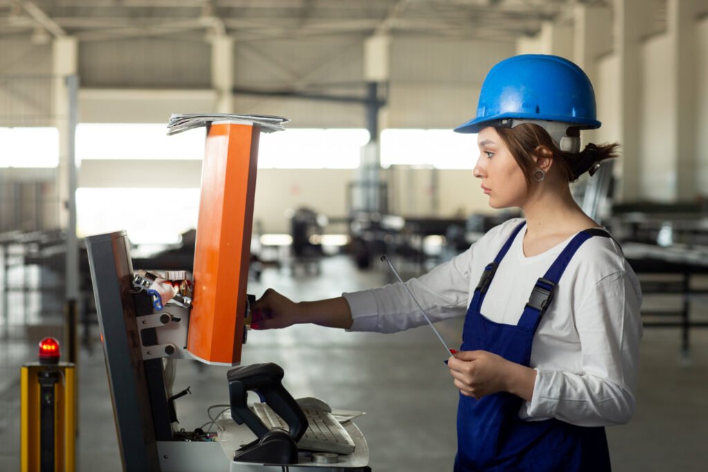 A female machinist operating a CNC machine in a well-equipped workshop, symbolizing women being trained in skilled trades.