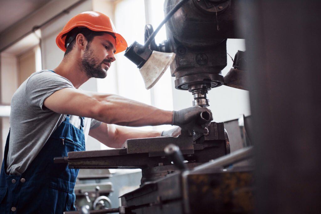 Skilled worker operating a CNC machine in a modern Ontario manufacturing facility, highlighting rising demand for CNC skills and manufacturing jobs.